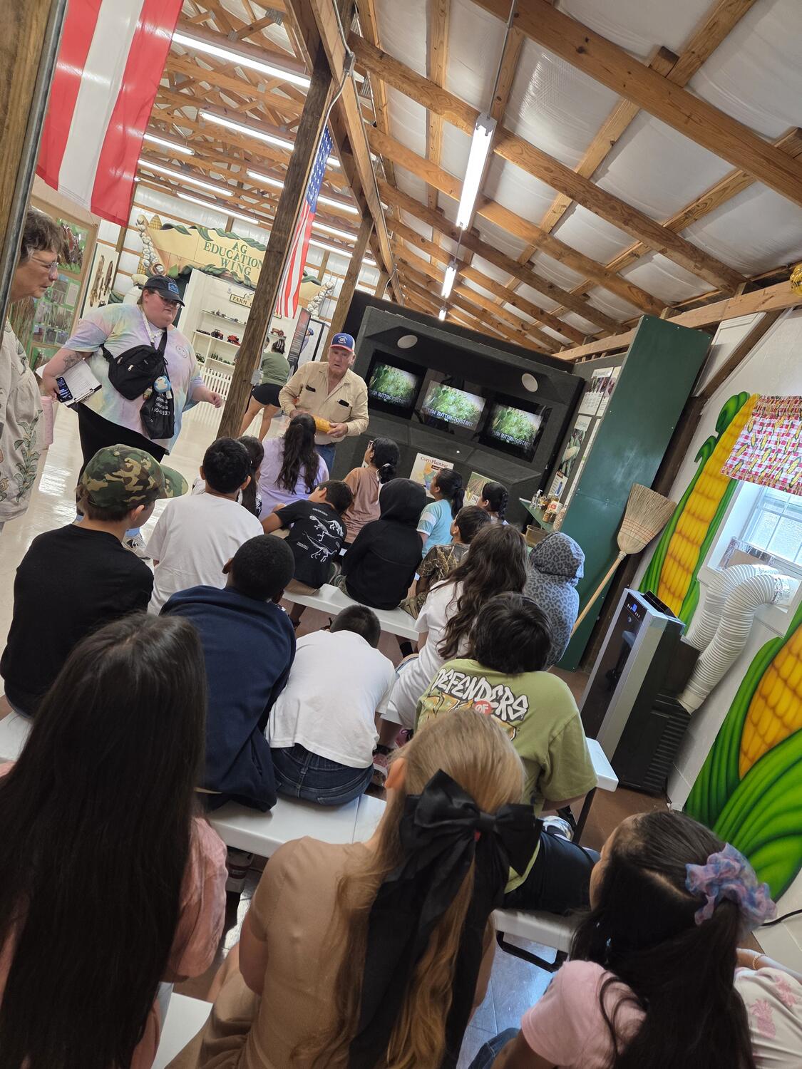 A presenter holds up an ear of corn for a class in the Ag Education Wing