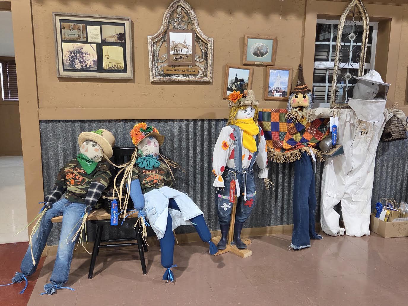 Youth scarecrow contest entries on display with award ribbons